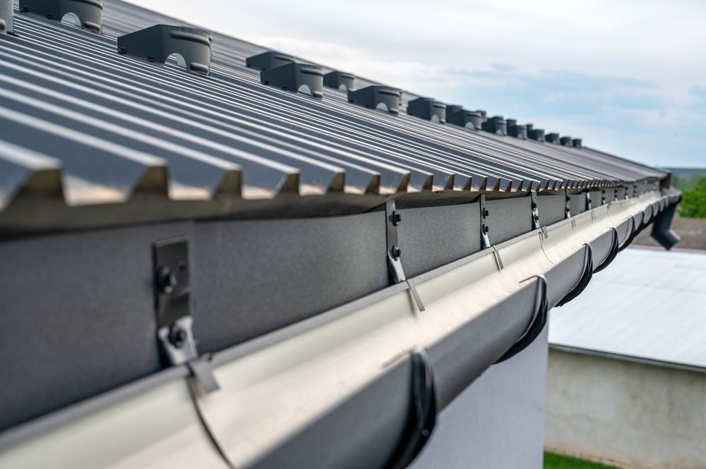 Close-up of a gray metal roof with a matching gutter system and vent caps — All-Clear Gutter Guard NQ in Cairns City, QLD