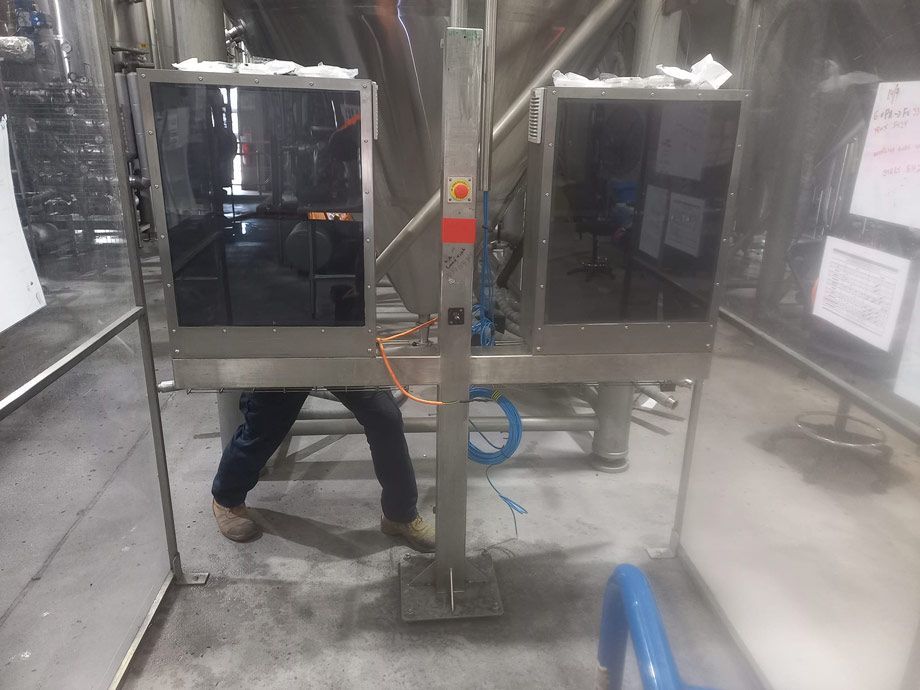 Man Is Standing In Front Of Two Monitors In A Factory — Vids Fabrication in South Lismore, NSW