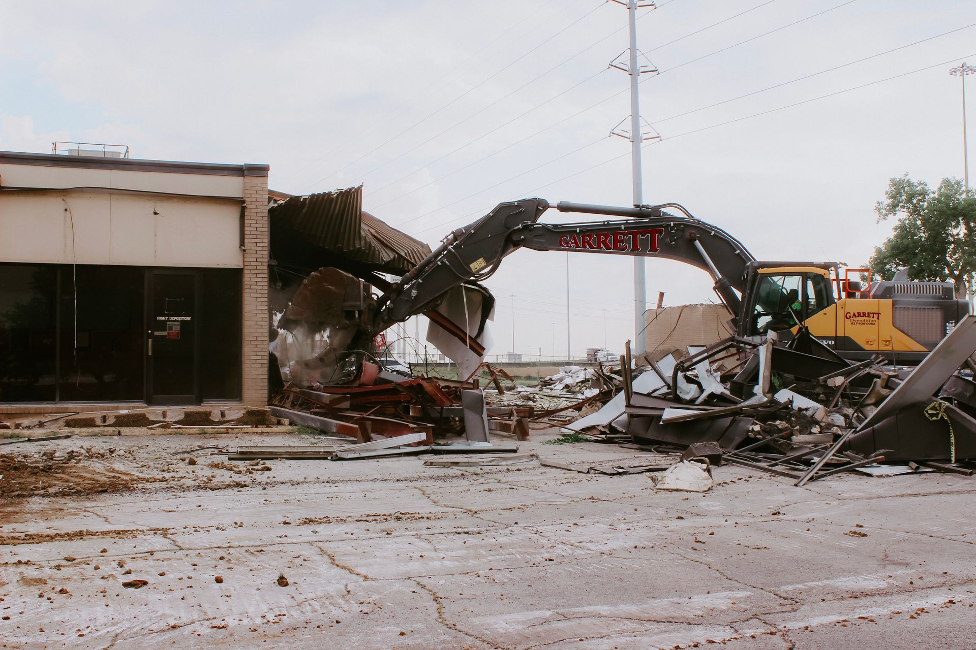 A volvo excavator is demolishing a building