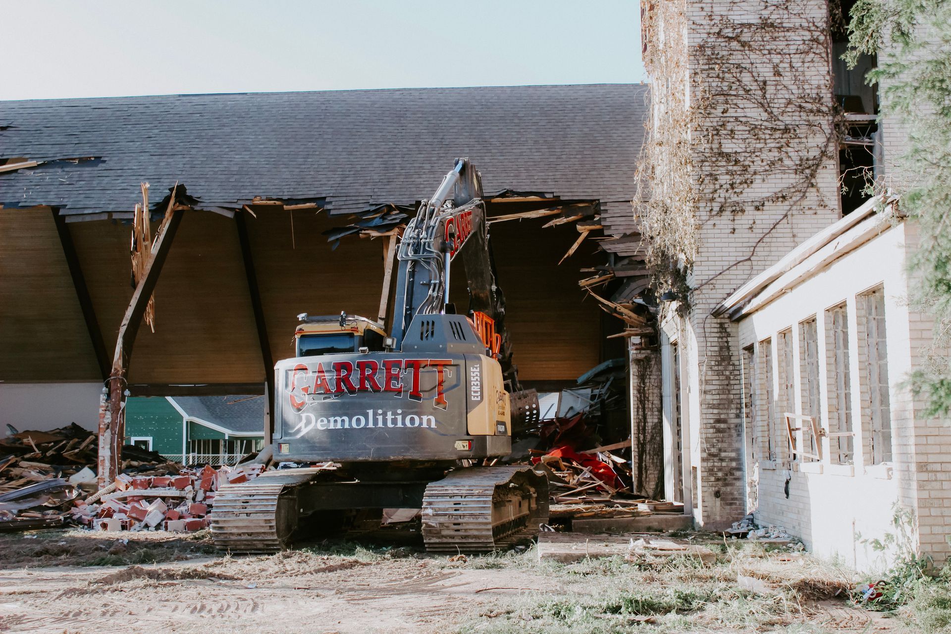 A large excavator is being used to demolish a building.