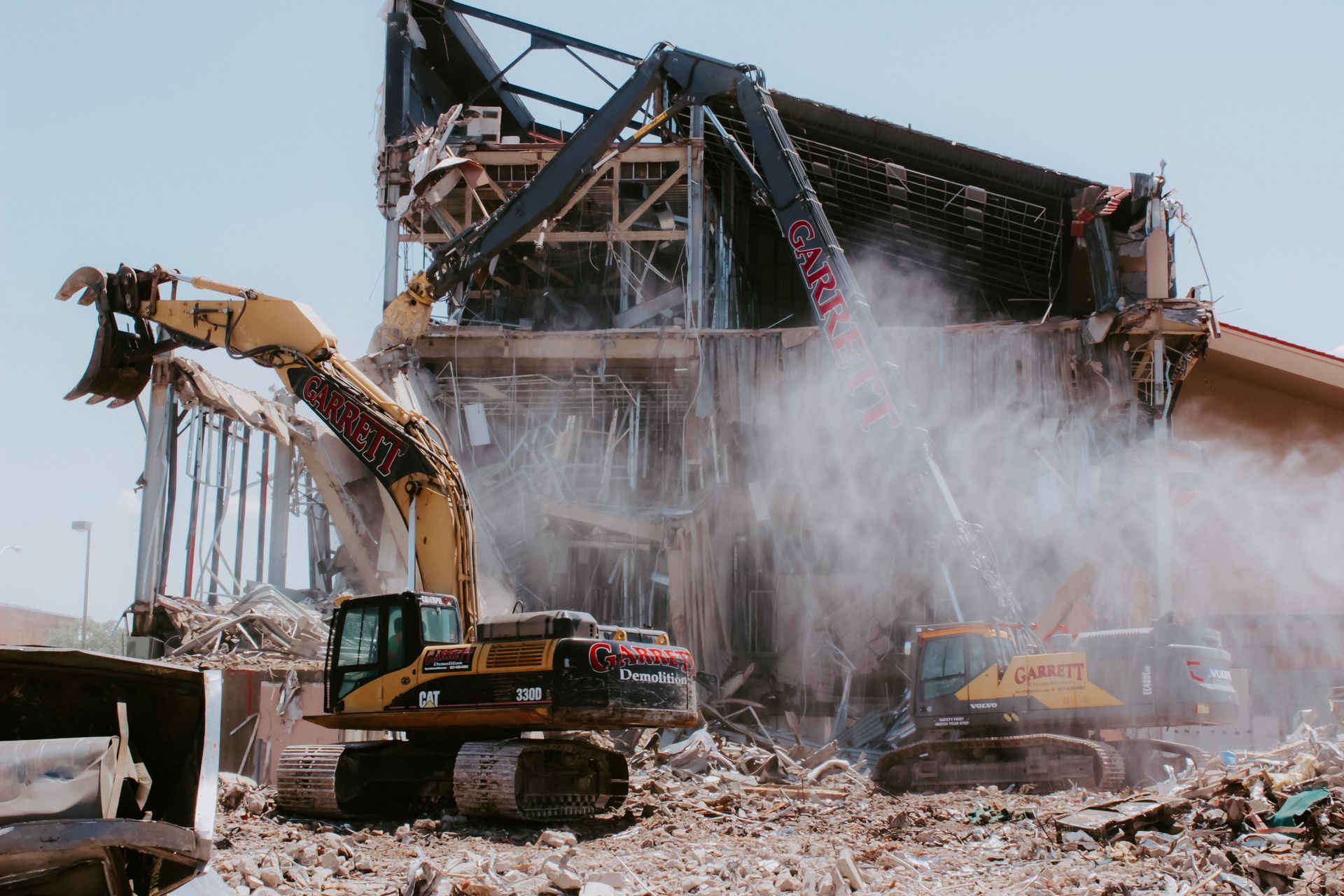 A large building is being demolished by a bulldozer.