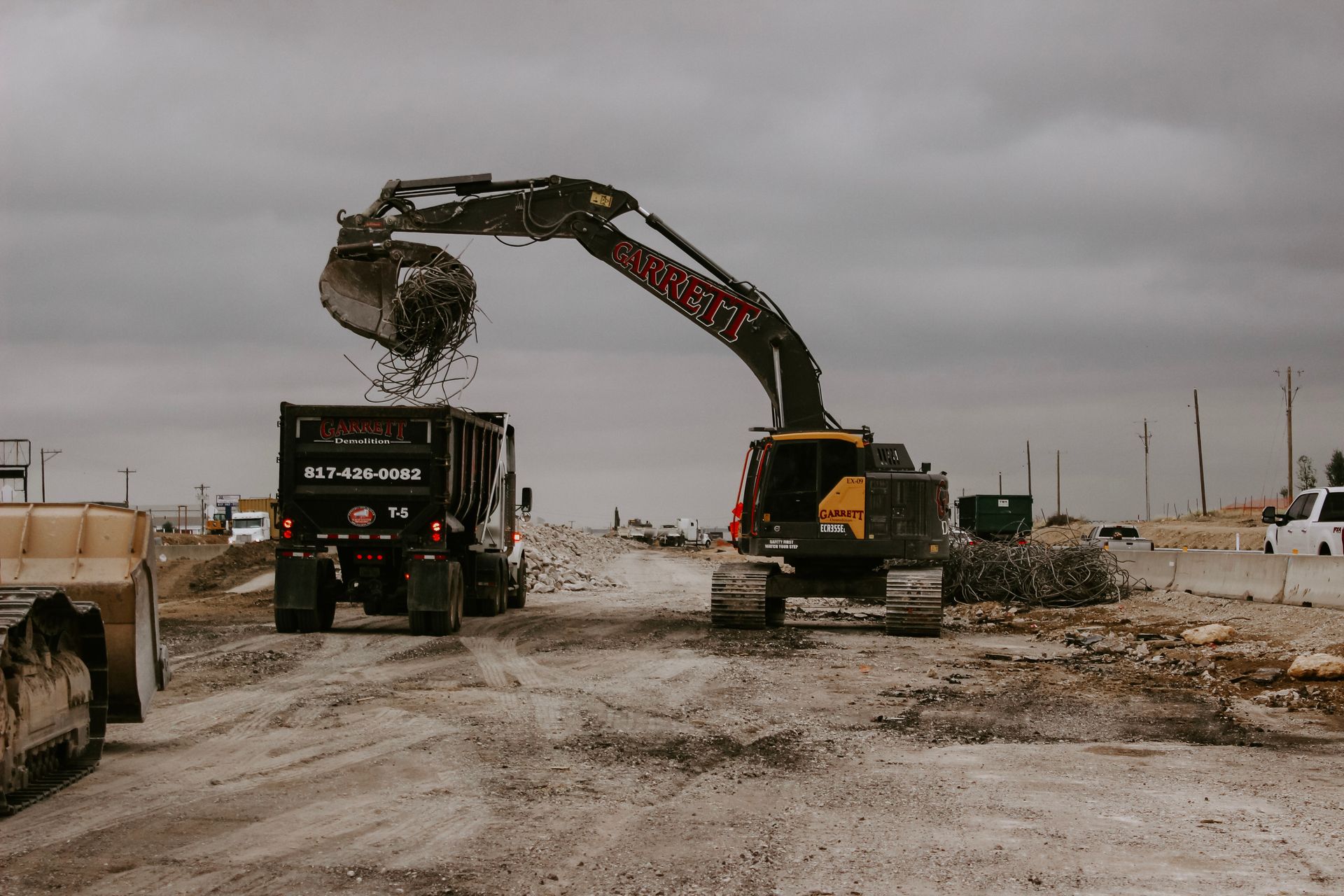 An excavator is loading dirt into a dump truck.