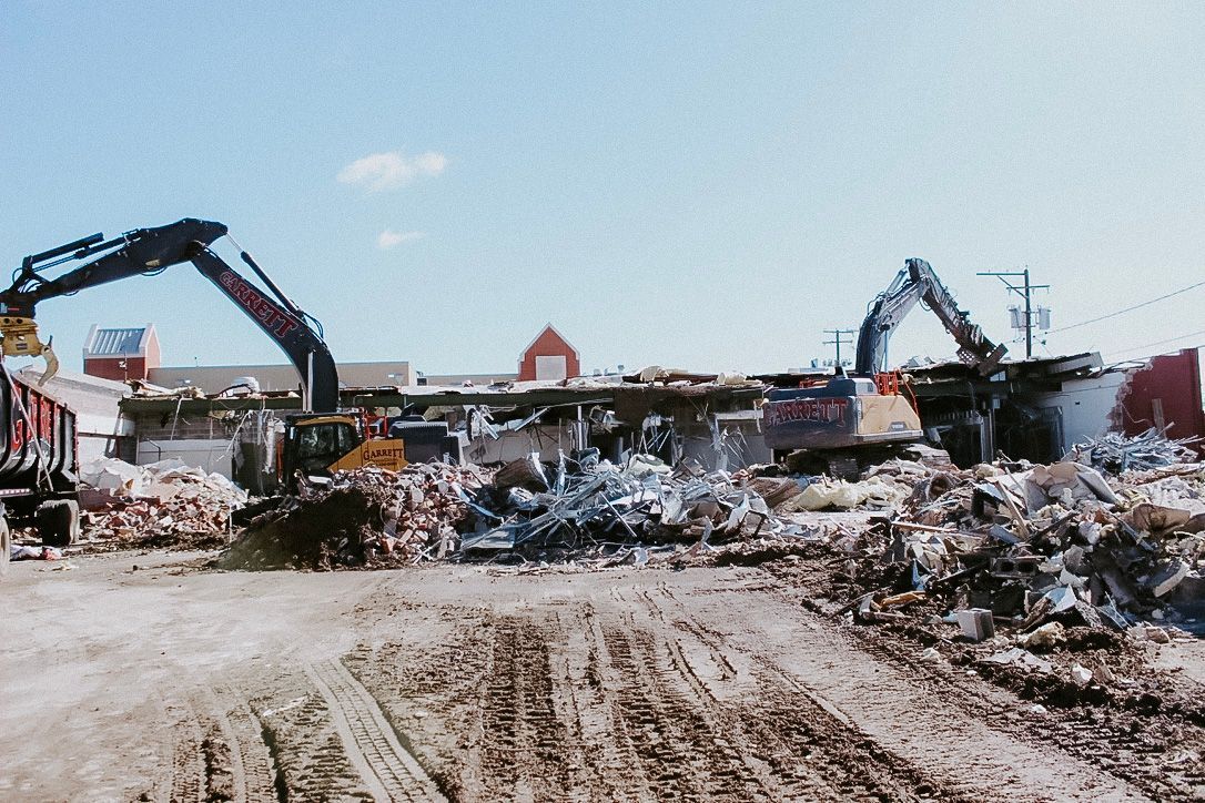Two excavators are working on a construction site.