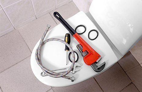 Poor Drain — Plumber's Tools on Toilet at Home in Griffin, Ga