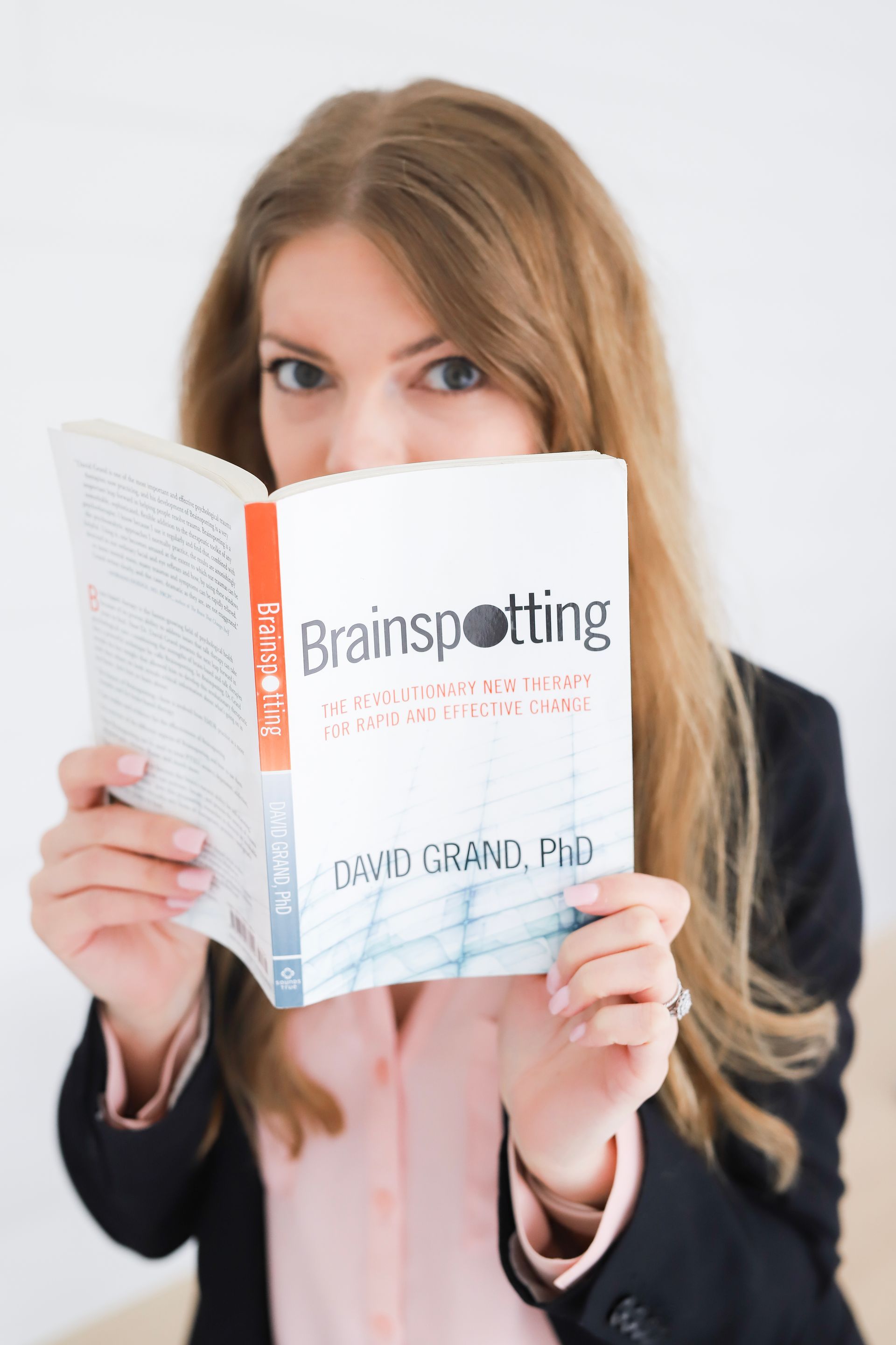 Cherie Spellman Brainspotting Consultant holding Brainspotting book