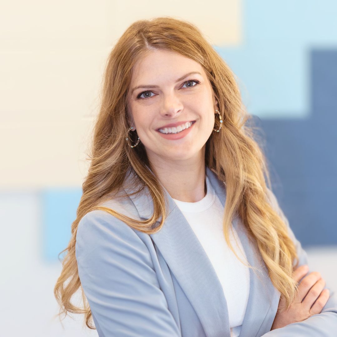 a brainspotting therapist in a blue jacket and white shirt is smiling in Grapevine Texas