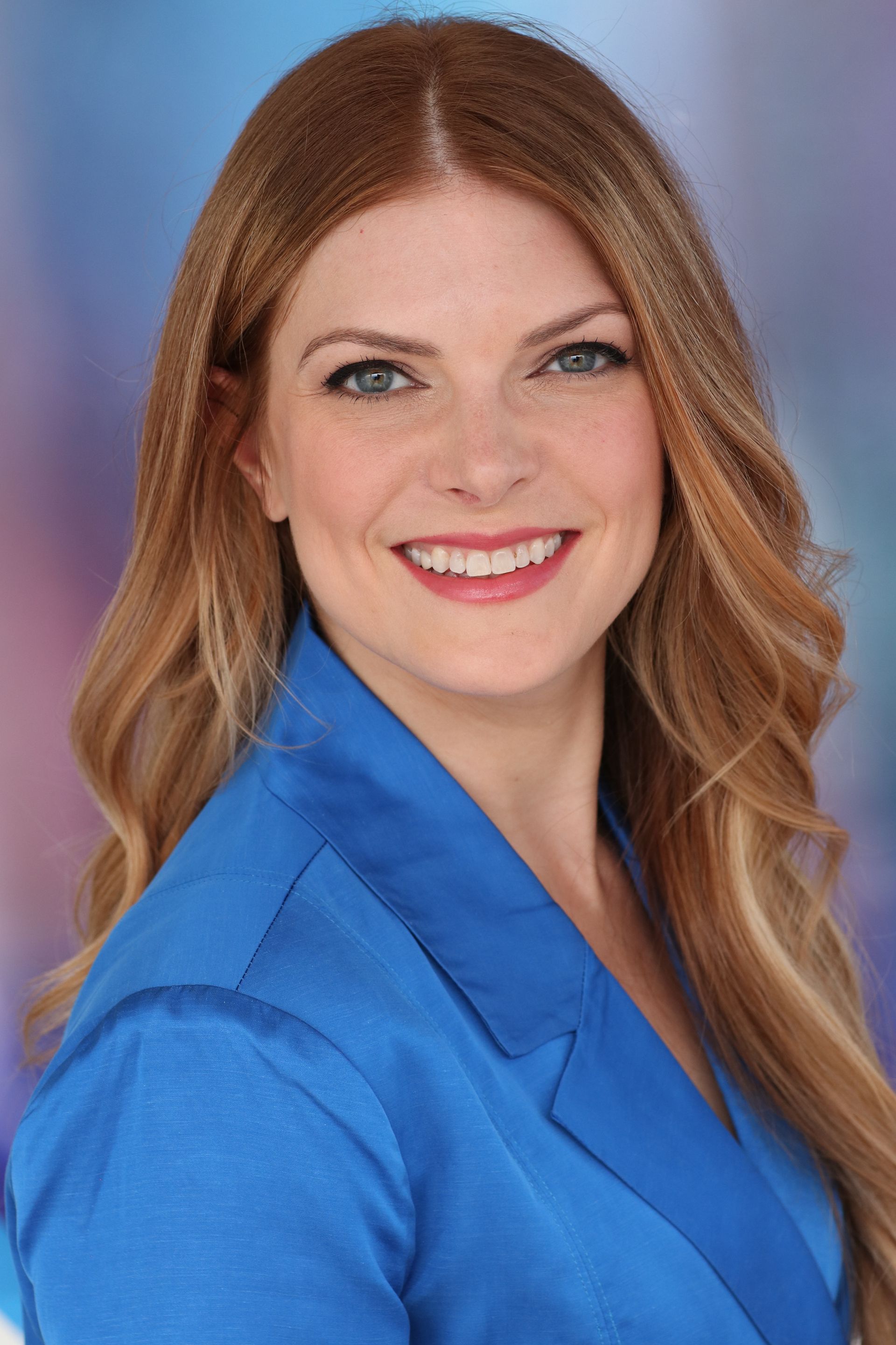 a brainspotting intensive therapist for trauma and chronic pain in a blue jacket and white shirt is smiling in Grapevine Texas