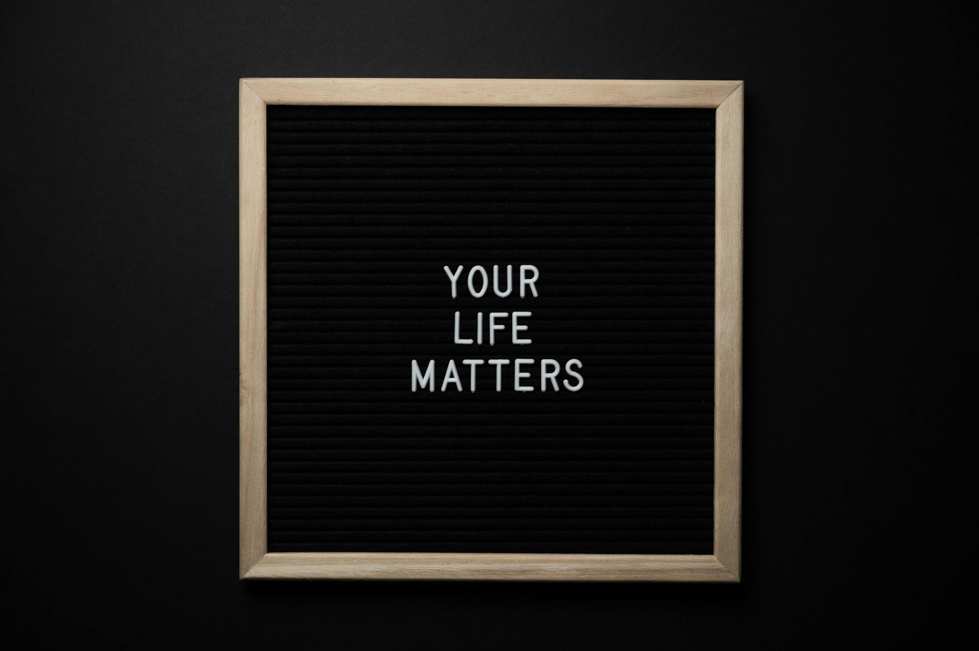 A black letter board with the words `` your life matters '' written on it.