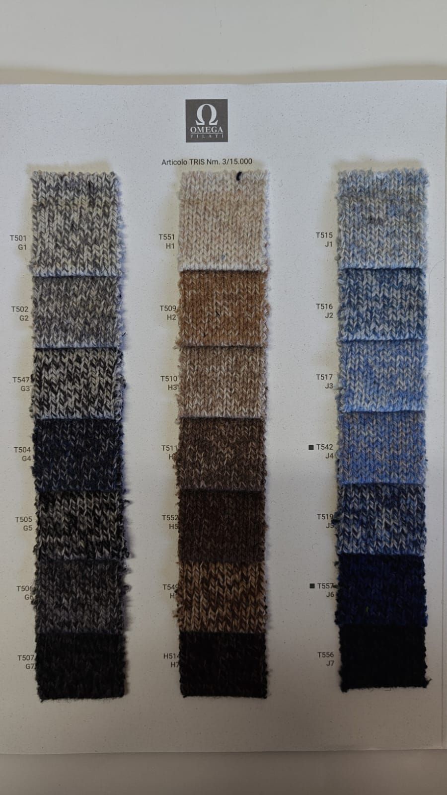 Tarjeta muestraria de telas con tres columnas de muestras texturizadas en tonos azules, marrones y grises.