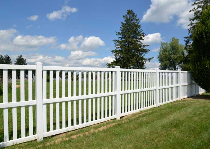 a wide white vinyl fence
