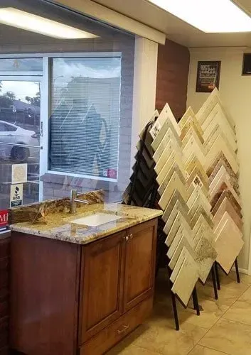 A bathroom with a sink and a display of tiles.