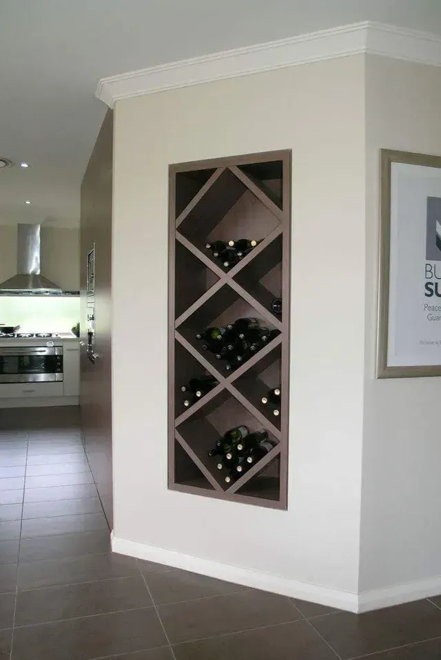 A corner of a room with a wine rack and a picture on the wall.