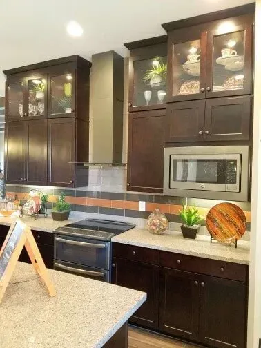 A kitchen with a stove, microwave, and cabinets.