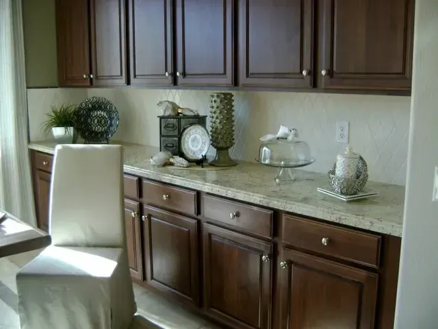A kitchen with wooden cabinets and granite countertops.