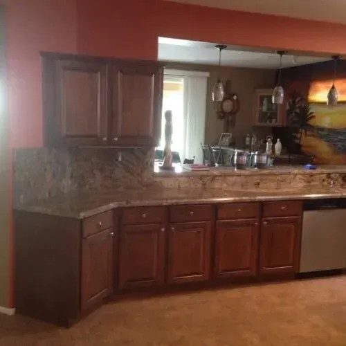 A kitchen with wooden cabinets and granite countertops.