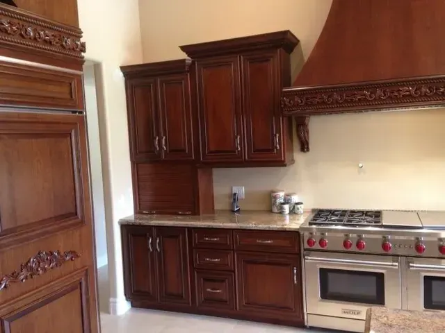 A kitchen with stainless steel appliances and wooden cabinets.