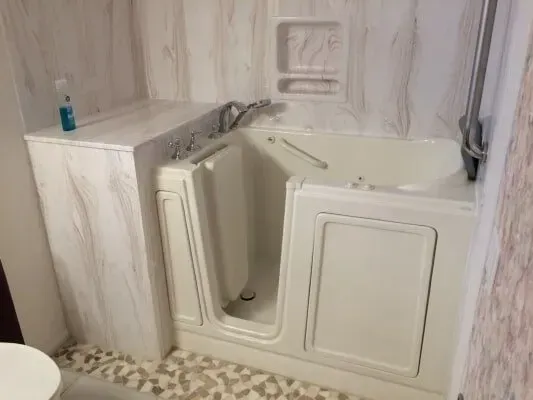 A bathroom with a walk in tub and a toilet.