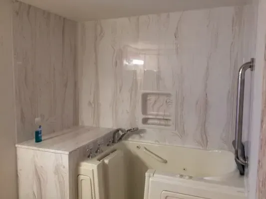 A bathroom with a walk in tub and a shower.