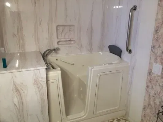 A walk in tub with a handle on the side of it in a bathroom.