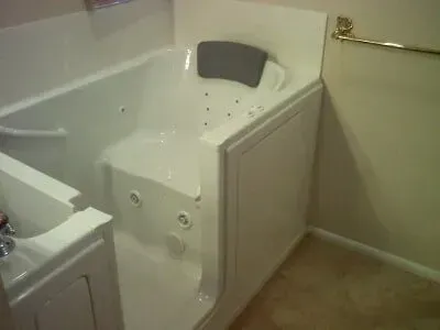 A walk in tub with a door in a bathroom.