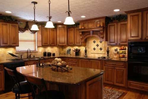 A kitchen with wooden cabinets and granite counter tops.