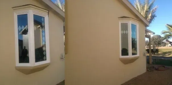 A house with two windows on the side of it.