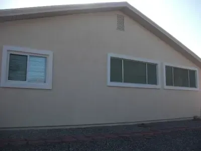 A house with a lot of windows on the side of it.