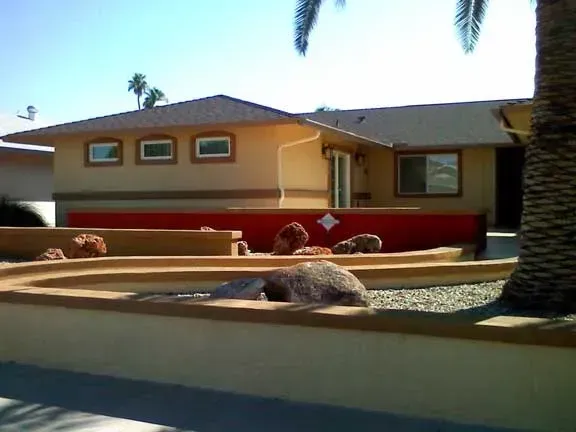 A house with a palm tree in front of it.