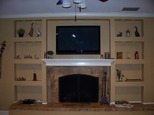 A fireplace with a flat screen tv above it.