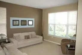 A living room with a couch and a window