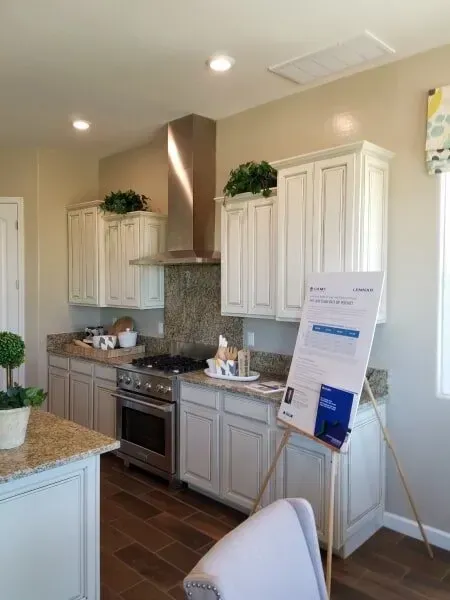 A kitchen with white cabinets and stainless steel appliances.