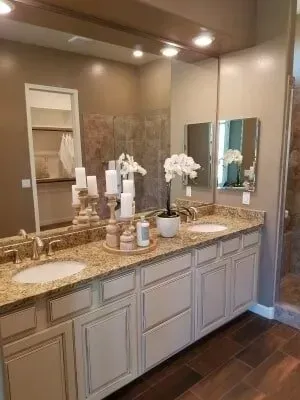A bathroom with two sinks and two mirrors.