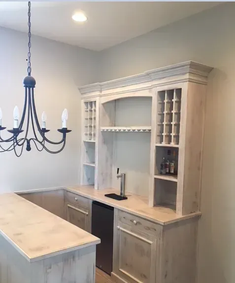 A kitchen with white cabinets and a chandelier hanging from the ceiling.