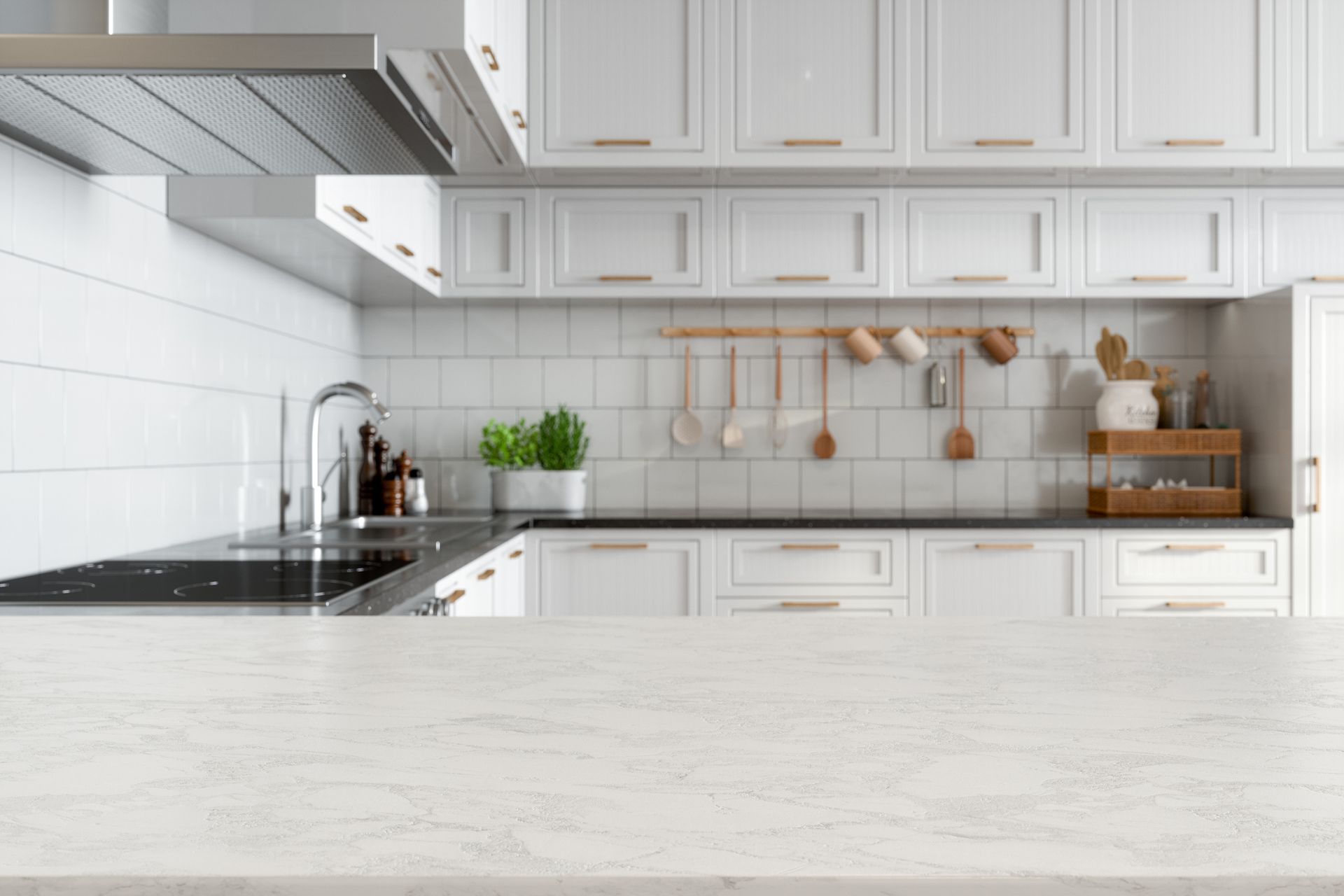 White kitchen with marble countertop, cabinets, and stainless steel appliances.