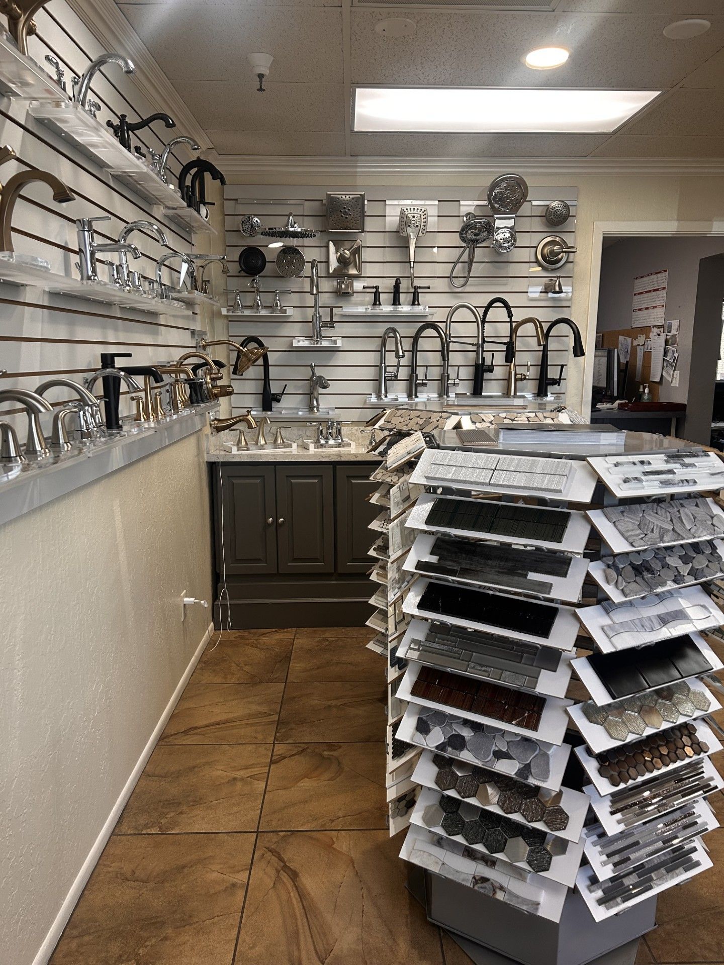 Showroom displaying various faucets and tile samples.