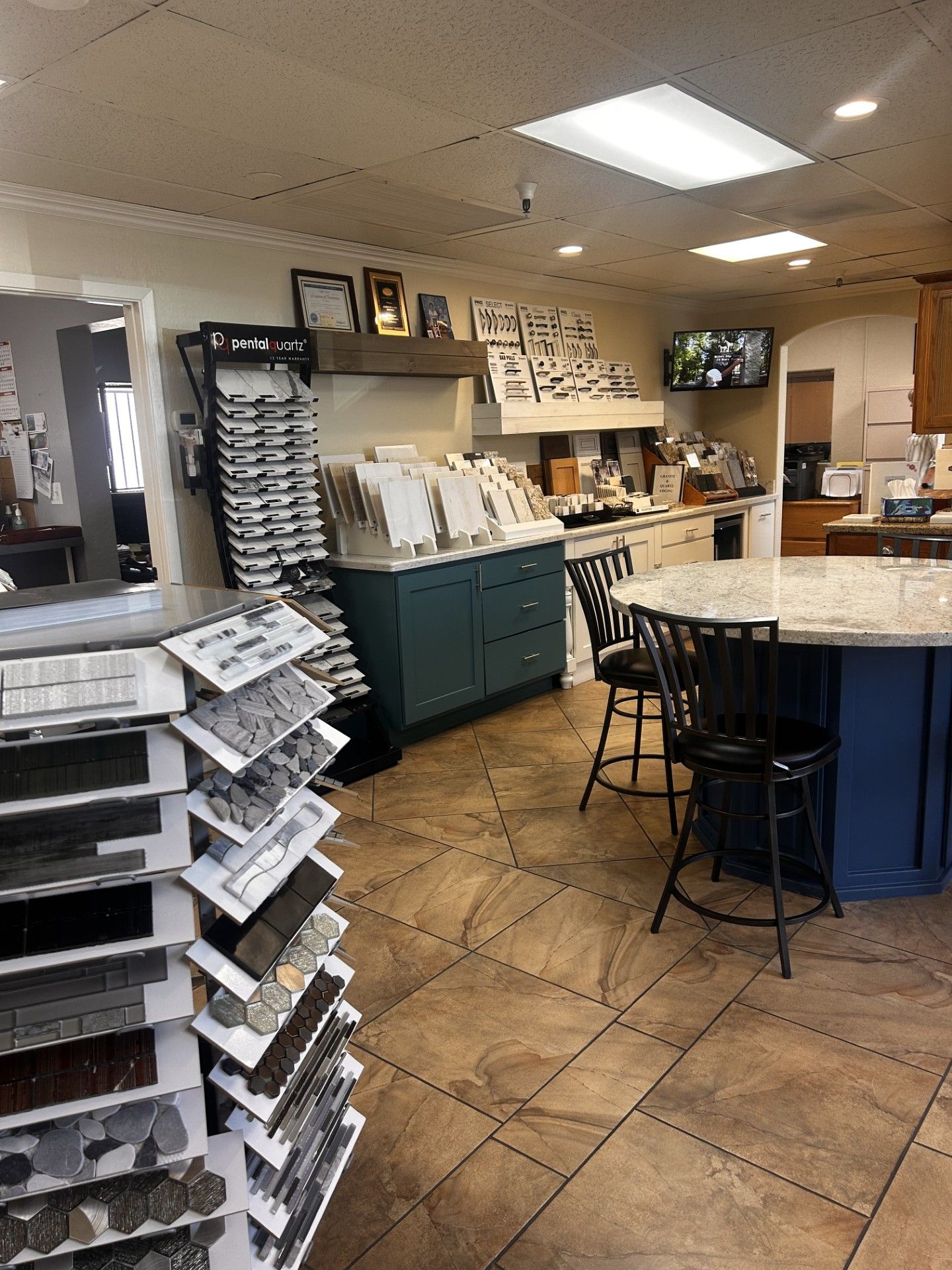 Tile showroom interior with displays, kitchen island, and samples.