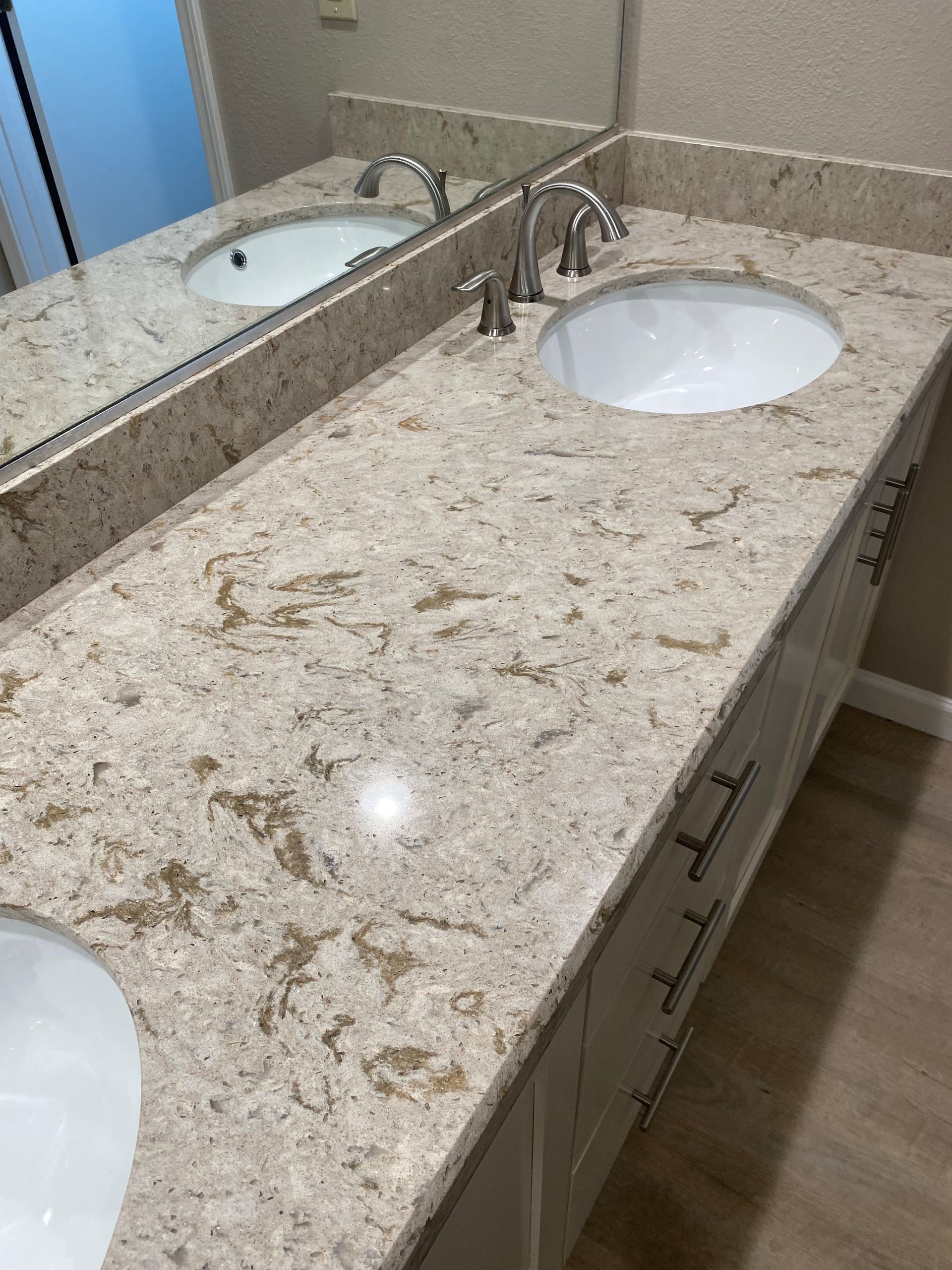 A bathroom with two sinks and a mirror.