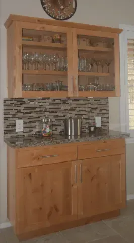 A kitchen with wooden cabinets and a granite countertop.