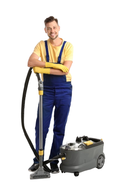 A man in blue overalls is standing next to a vacuum cleaner.