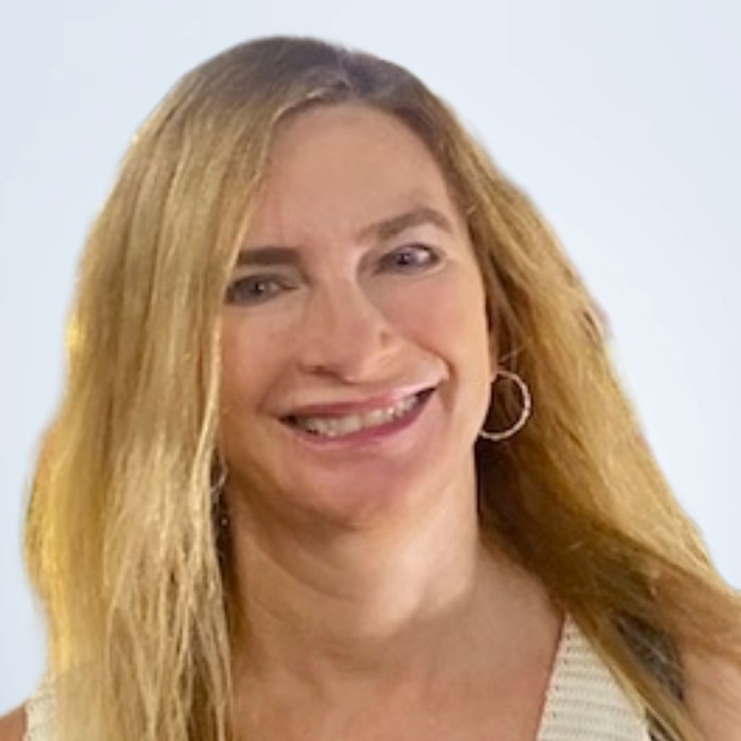 Smiling woman with long blonde hair, wearing a white and beige top, in front of a white background.