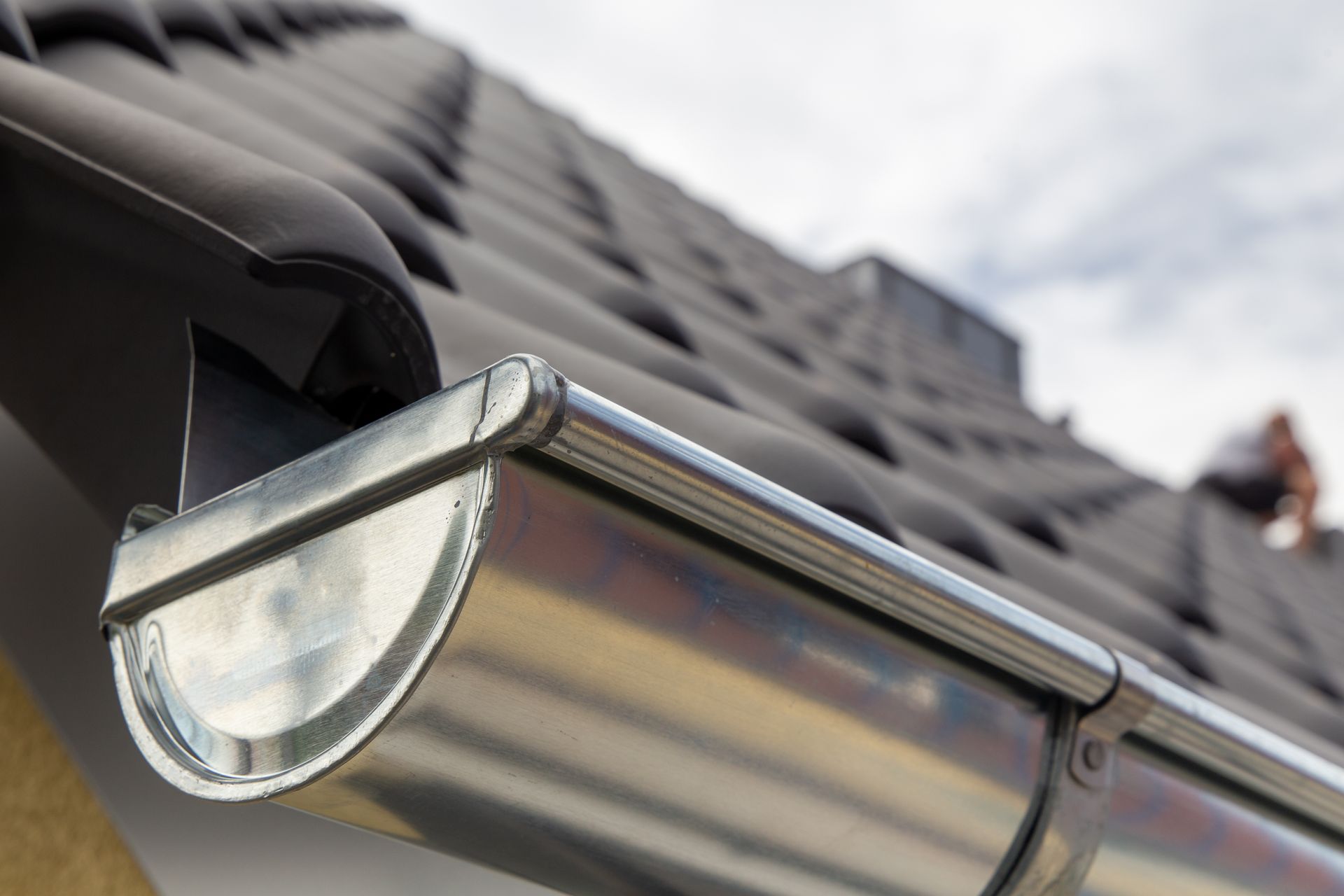 A close up of a metal gutter on a roof.