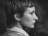 A black and white photo of a woman with short hair