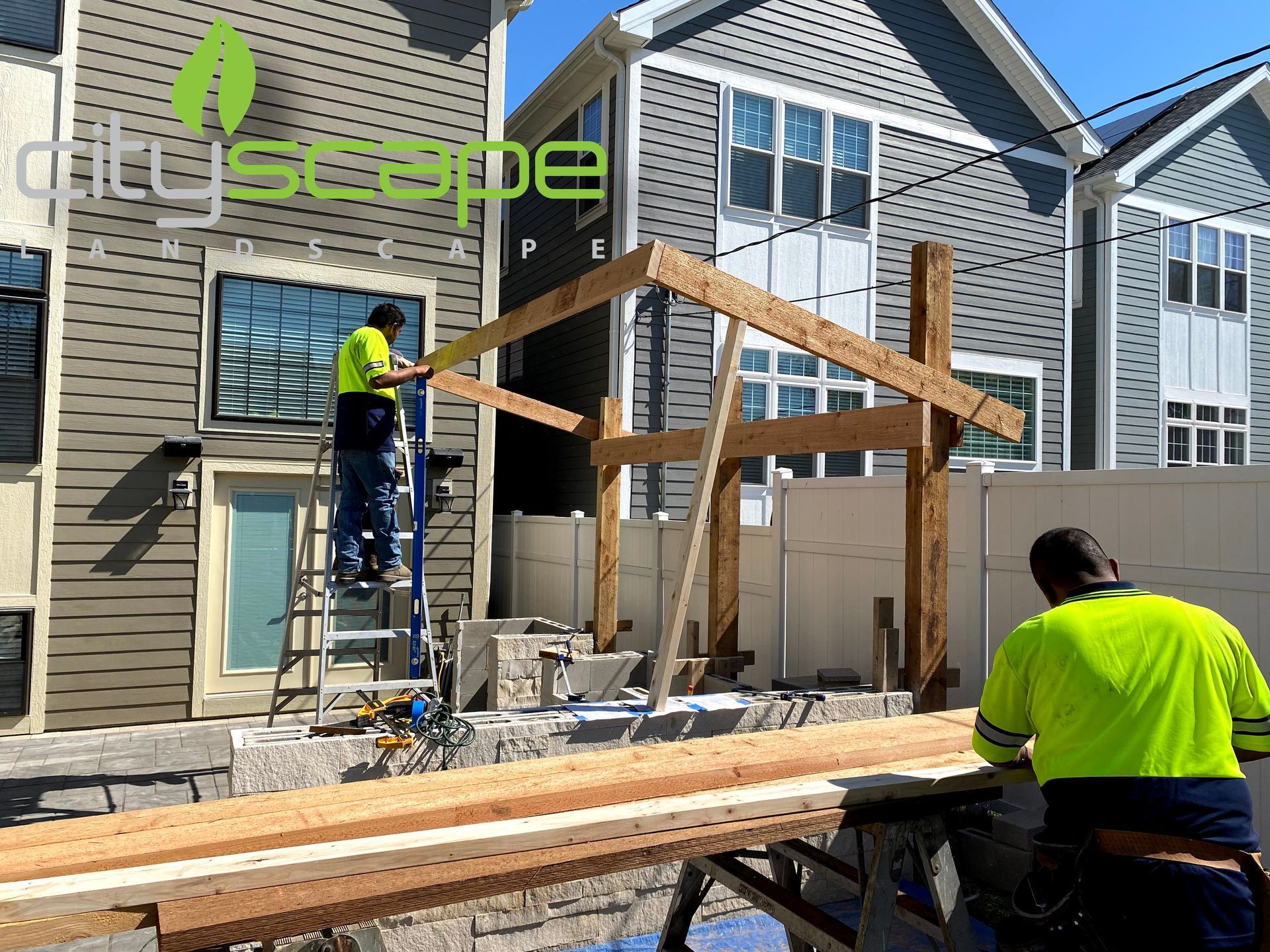 Construction workers building a wooden structure next to a building. Cityscape logo visible.