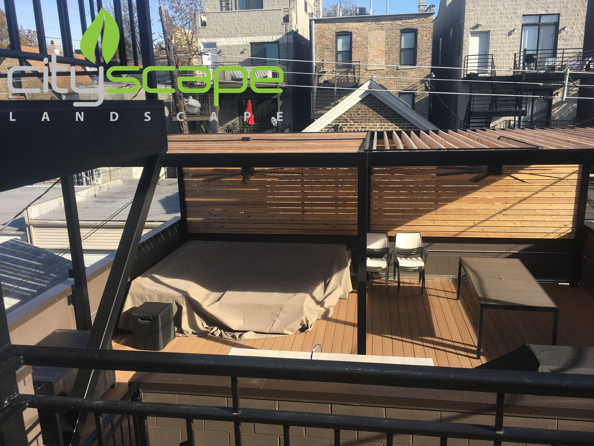 Rooftop deck with wooden pergola and furniture; sunny day, urban setting.