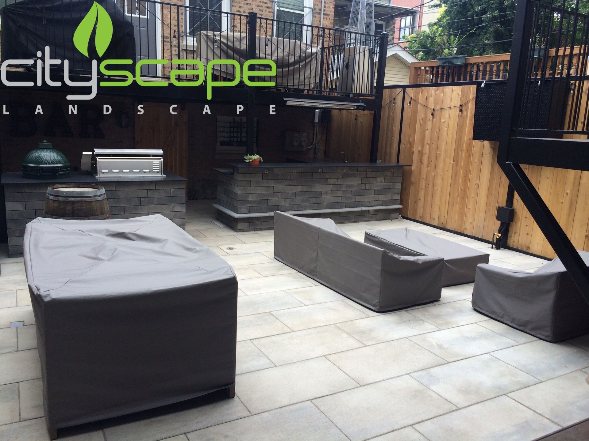 Outdoor patio with covered furniture, built-in grill, and wood fence; Cityscape Landscape logo visible.