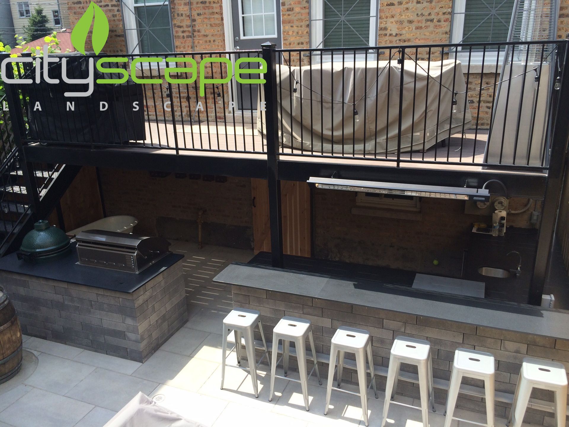 Outdoor patio with a bar, seating, and a grill area.