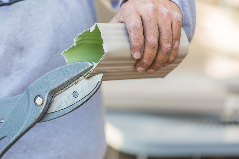 Man Repairing Roof Gutter
