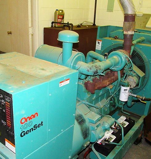 A teal Orion 100 GenSet generator, in a utility room, with visible exhaust and control panel.