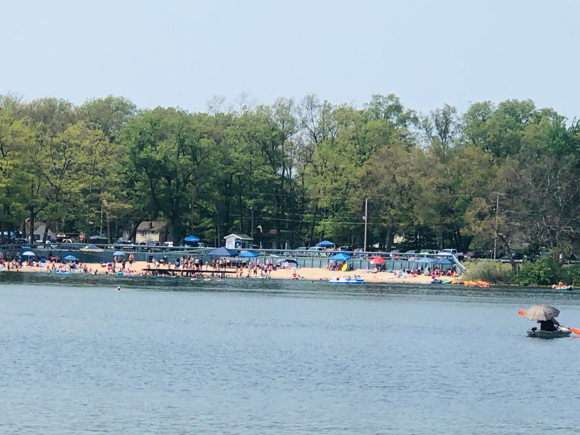 A large body of water with a beach in the background.
