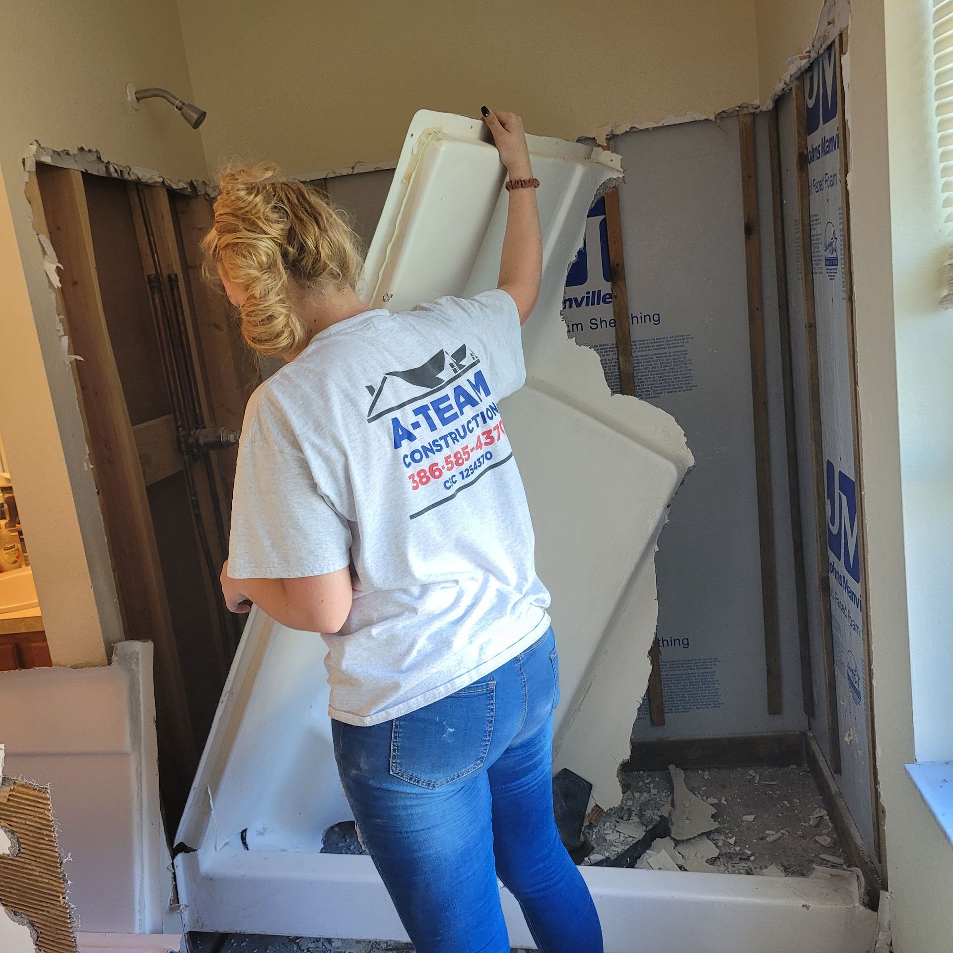 A woman wearing a white shirt that says a-team